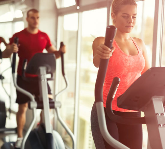 People using gym equipment in a sports centre - Boyd Insurance