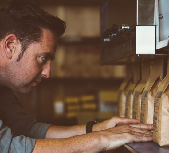 A man ensuring artisan coffee is correctly packaged - Boyd Insurance