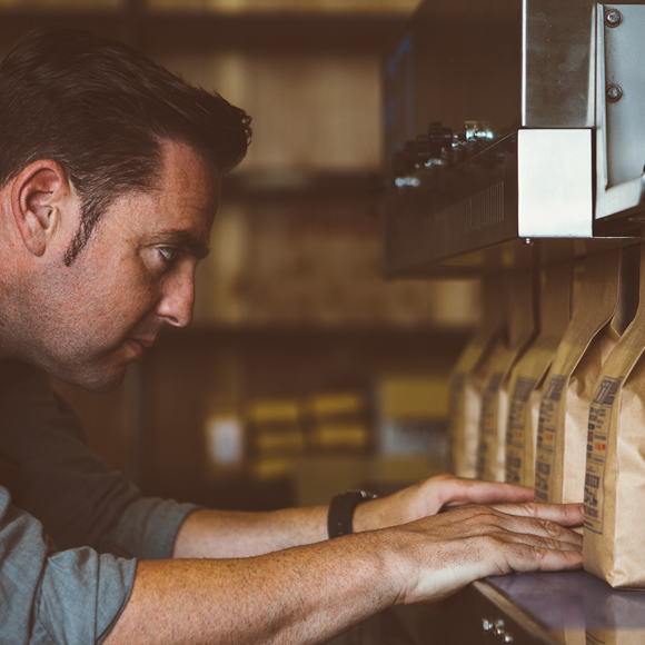 A man ensuring artisan coffee is correctly packaged - Boyd Insurance