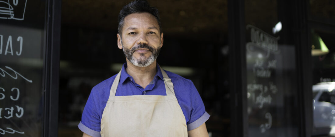 Portrait of owner / waiter using digital tablet at restaurant