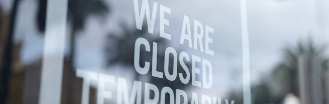 shot of store closed sign